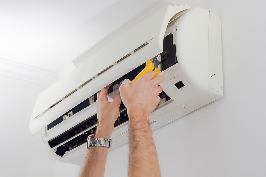 Cropped Image Of Technician Servicing Air Conditioner