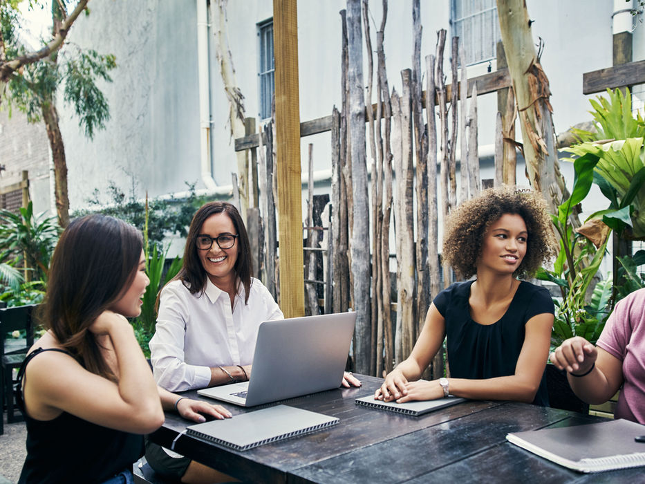 Four women at a meeting at the Serene Estate
