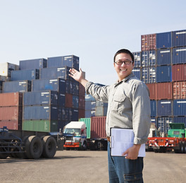 Smiling Person Standing In Front Of Container Yard