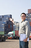 Smiling Person Standing In Front Of Container Yard