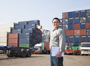 Smiling Person Standing In Front Of Container Yard
