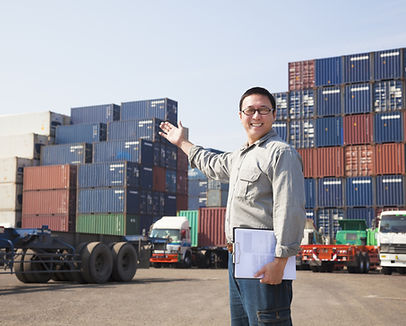 Smiling Person Standing In Front Of Container Yard