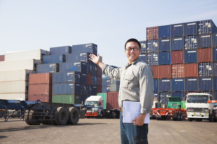 Smiling Person Standing In Front Of Container Yard