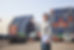 Smiling Person Standing In Front Of Container Yard