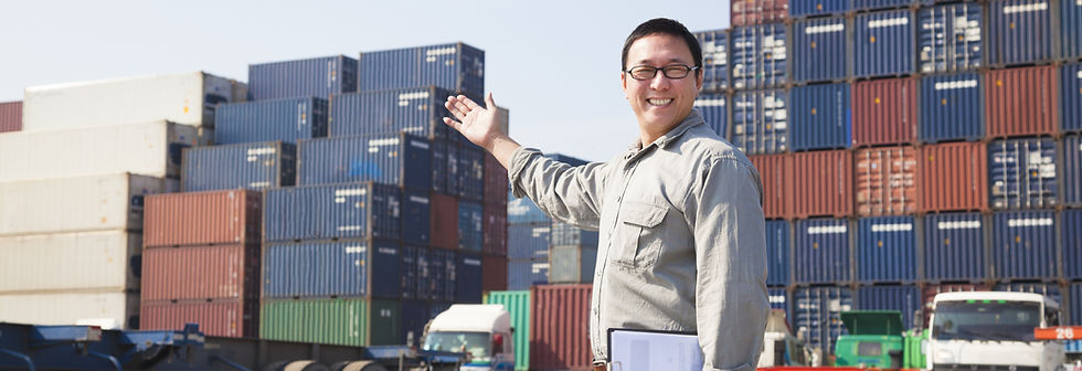 Smiling Person Standing In Front Of Container Yard