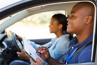 african american driving instructor inside a car