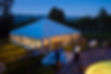 Party Tent Glowing Warm at Dusk with Cool Blue Light. Entertainment catering tent at part