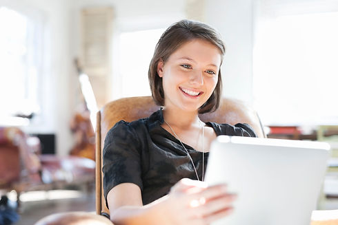 a smiling woman using tablet