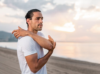 Man Stretching on Beach