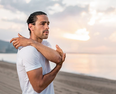 Man Stretching on Beach