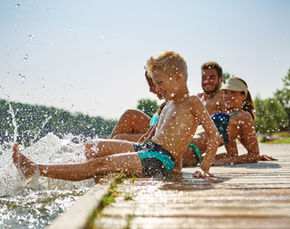 kids splashing water at a lake