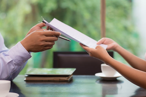 A businessman giving document to his female colleague