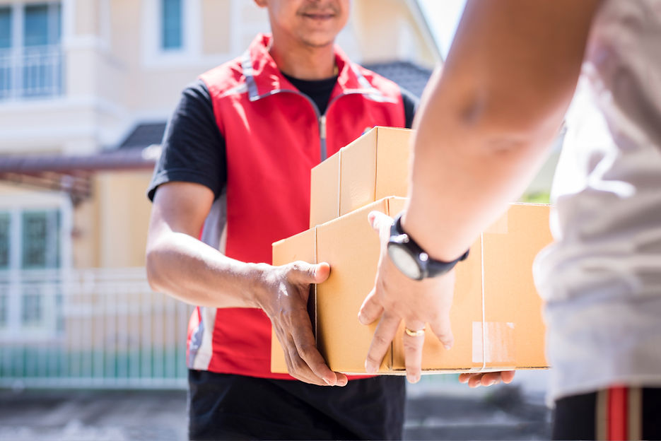 parcel delivery man of a package through a service and customer hand accepting a delivery