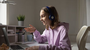 Teenager taking an online English course on a laptop
