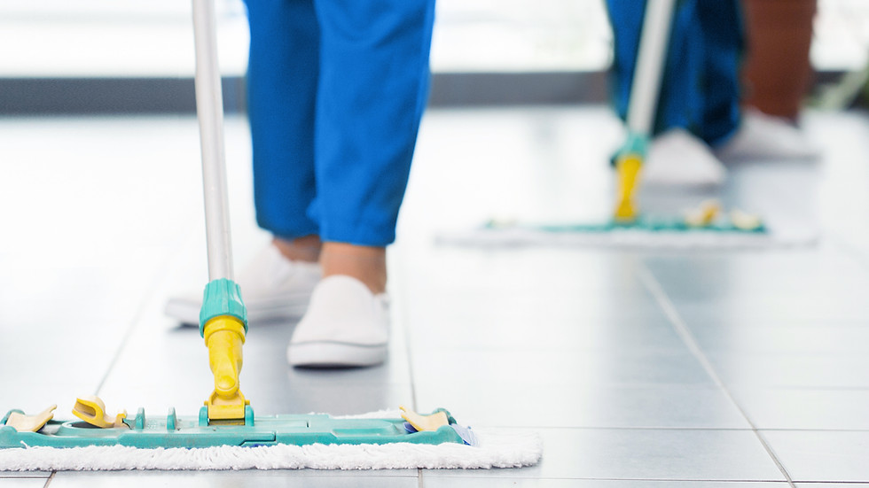Janitor mopping office floors for commercial cleaning service