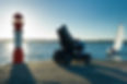 person on mobility scooter by the sea