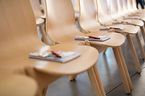Conference Seating, empty chairs with pen and note pads on them