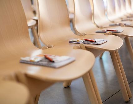 Conference Seating, empty chairs with pen and notedbook on them