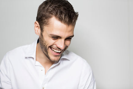 Portrait of smiling young man looking downward