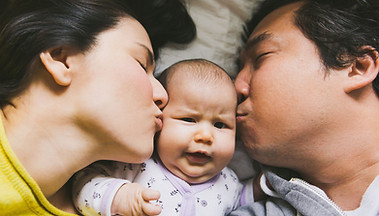 Family Kissing Baby
