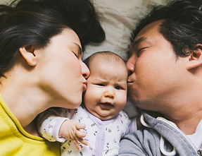 Family Kissing Baby