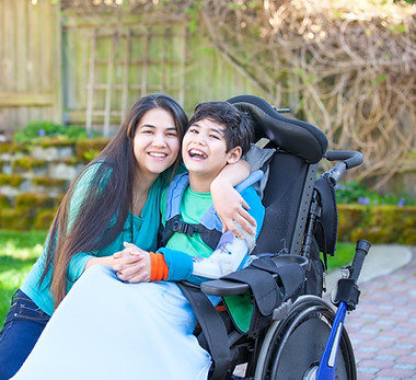A woman hugging a disable child