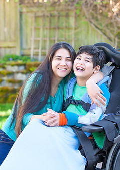 A woman hugging a disable child