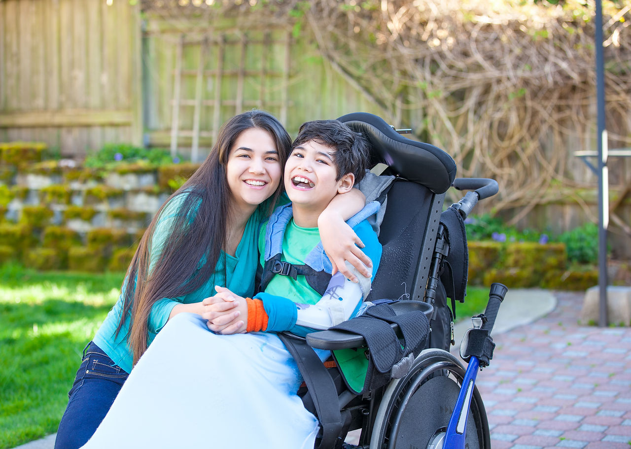 A woman hugging a disable child
