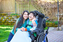 A woman hugging a disable child