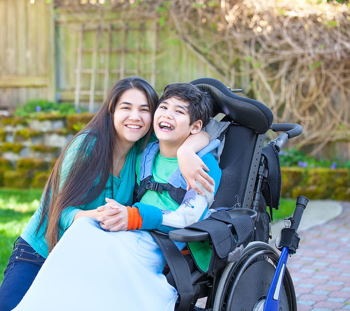 A woman hugging a disable child
