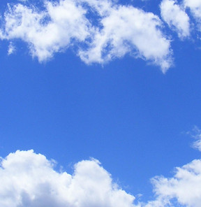 Puffy white clouds in a blue sky.