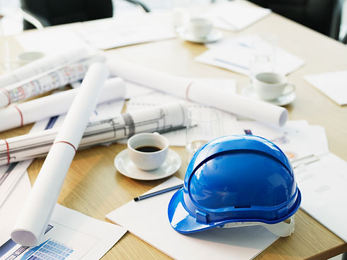 Table with hard-hat and blueprints