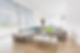 Living room with a clean grey sectional sofa and colourful pillows