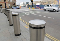 Firm columns creating a barrier between the road and the pavement for protection