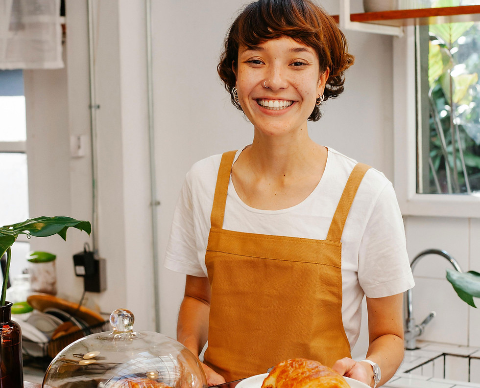 Smiling barista with croissant