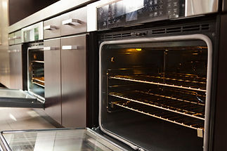 Modern built in ovens displayed in an appliance showroom