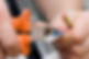 A person connecting wires with an orange plier