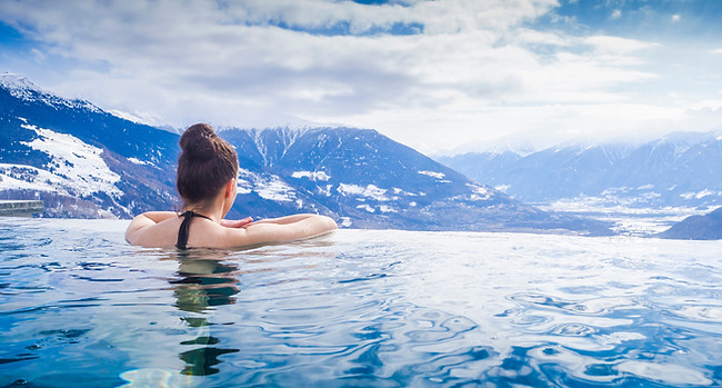 Woman in infinity pool in the mountains