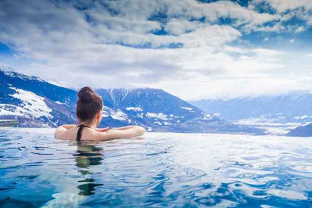 Woman in infinity pool in the mountains