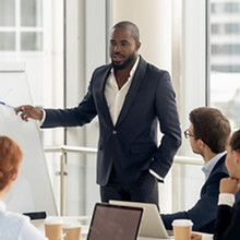 a business man presenting at a meeting