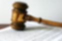 Wooden gavel resting on a legal document