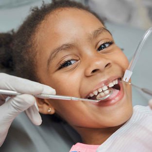 little girl at the dentist smiling