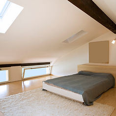 A clean and minimalist bedroom within a newly completed loft conversion