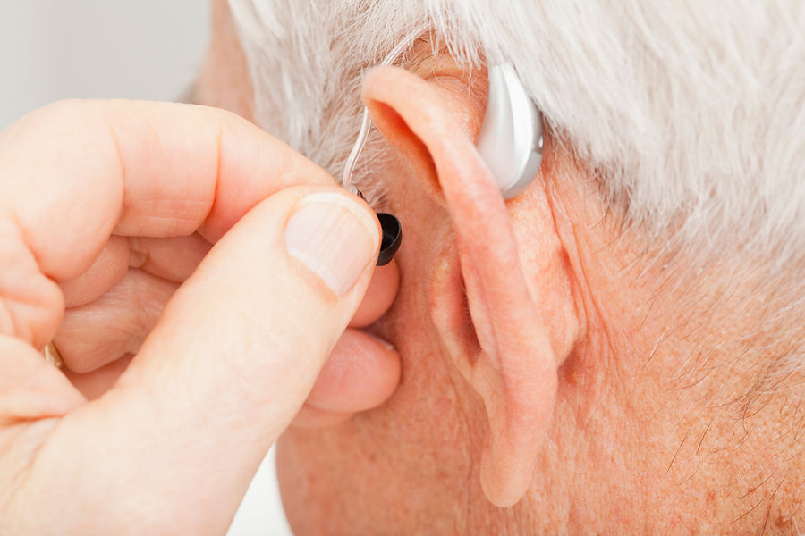 Close up of senior man's ear with hearing aid
