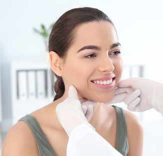 Woman getting a laser facial assessment