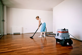 Woman mopping wooden floor at home