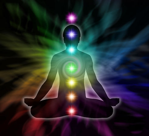Silhouette of a man in lotus meditation position with Seven Chakras on flowing rainbow.