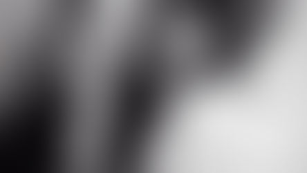 Black and white image of two people sharing a tender moment, one gently caressing the other's face, capturing the warmth and connection of feeling heard.