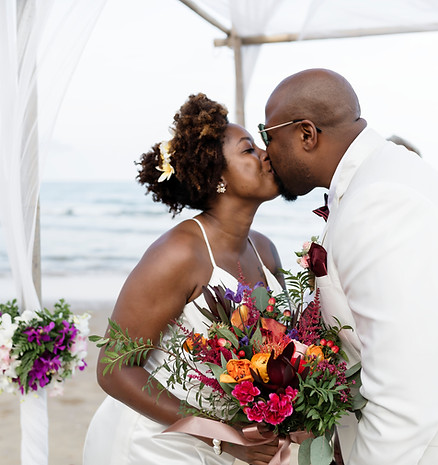 Beach wedding couple kissing