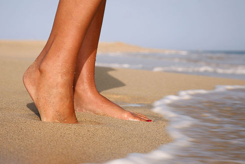 Feet in the sand on beach